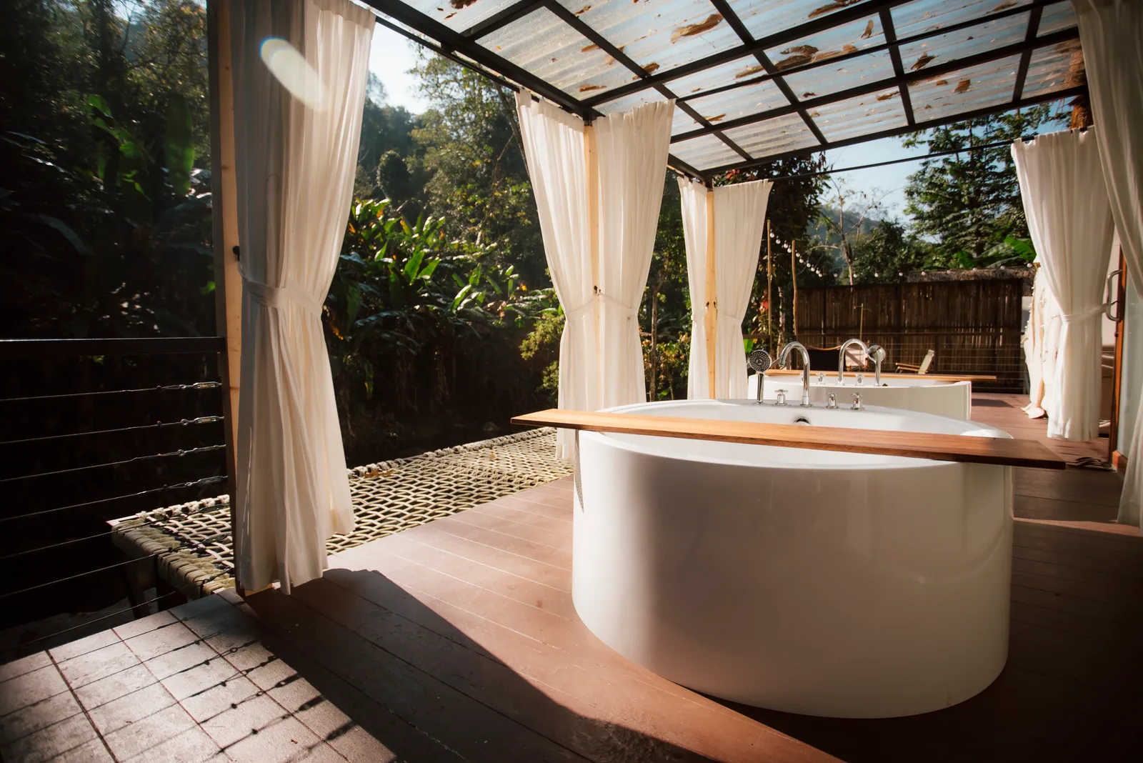 A freestanding outdoor bath surrounded by forest at Mornery